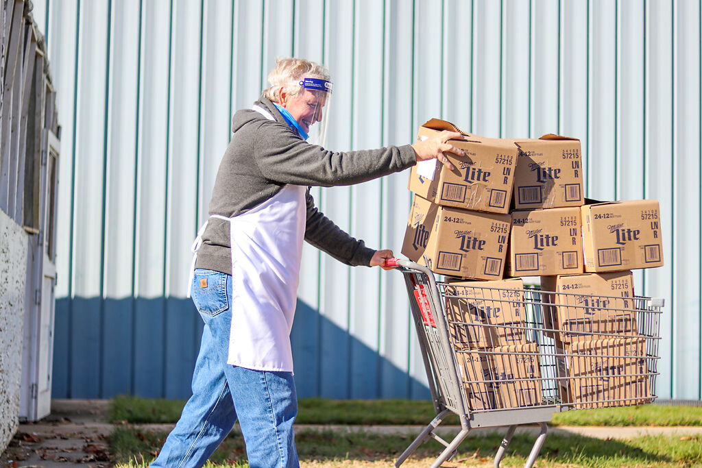 Ron Campbell guides a shopping cart full of boxed turkeys